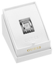 A silver-tone Guess wristwatch ring with a diamond-embellished dial and matching bracelet, presented inside an open white Guess gift box with gold lettering.