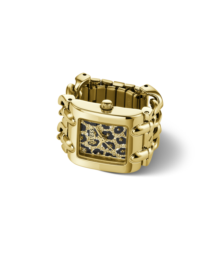 A gold-tone rectangular watch ring with a patterned dial featuring black, gold, and white spots, set against a clean white background.