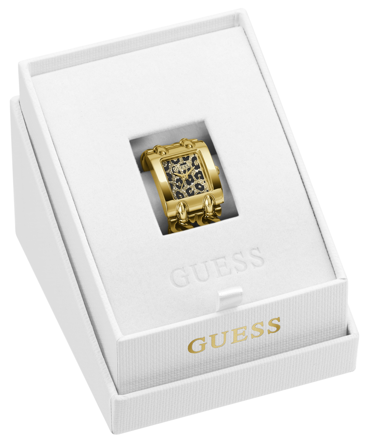 A gold-tone rectangular watch ring with a black and gold patterned dial, presented inside a white Guess gift box.