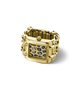 A gold-tone rectangular watch ring with a patterned dial featuring black, gold, and white spots, set against a clean white background.