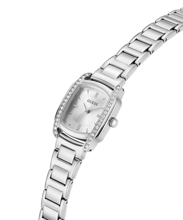 A silver-tone stainless steel women's watch by Guess, featuring a rectangular bezel encrusted with clear crystals, a silver dial with a date window, and a matching steel link bracelet, shown on a plain white background. lifestyle