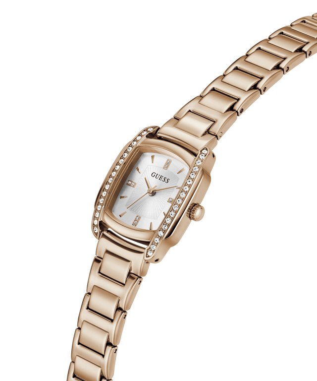 A silver-tone stainless steel women's watch by Guess, featuring a rectangular bezel encrusted with clear crystals, a silver dial with a date window, and a matching steel link bracelet, shown on a plain white background. lifestyle