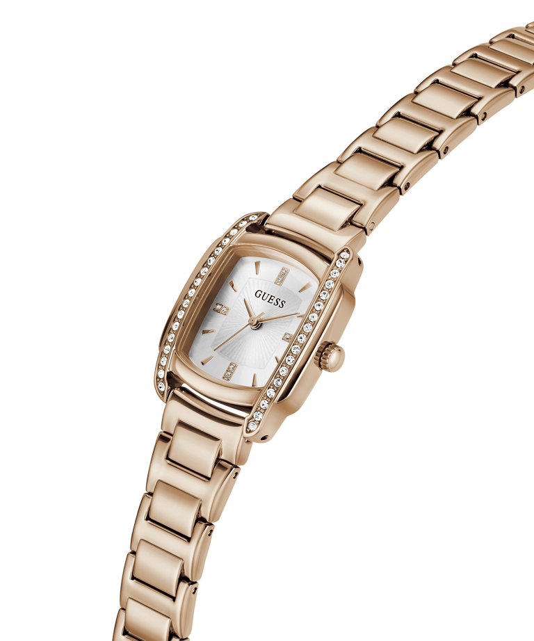 A silver-tone stainless steel women's watch by Guess, featuring a rectangular bezel encrusted with clear crystals, a silver dial with a date window, and a matching steel link bracelet, shown on a plain white background. lifestyle