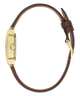 A side profile view of a watch with a gold-tone case and a brown leather strap, shown on a solid white background.