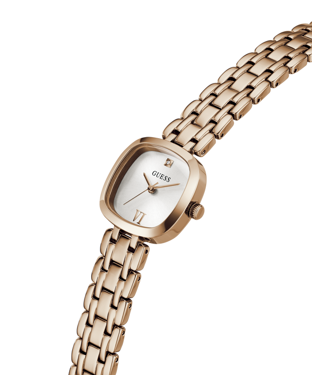 A GUESS women's watch featuring a rose gold-tone case and integrated link bracelet, with a white dial and a small diamond-shaped hour marker. lifestyle