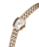 A GUESS women's watch featuring a rose gold-tone case and integrated link bracelet, with a white dial and a small diamond-shaped hour marker. lifestyle