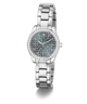 A women's Guess wristwatch with a silver-tone metal link bracelet, a bezel encrusted with clear rhinestones, and a blue-gray patterned dial featuring the Guess logo.