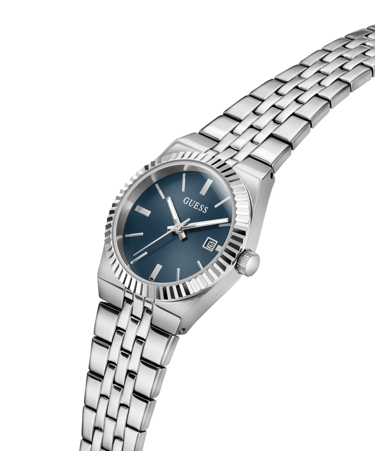 A Guess women's analog watch with a silver stainless steel link bracelet, a fluted bezel, and a dark blue dial with silver-tone hands and markers. lifestyle