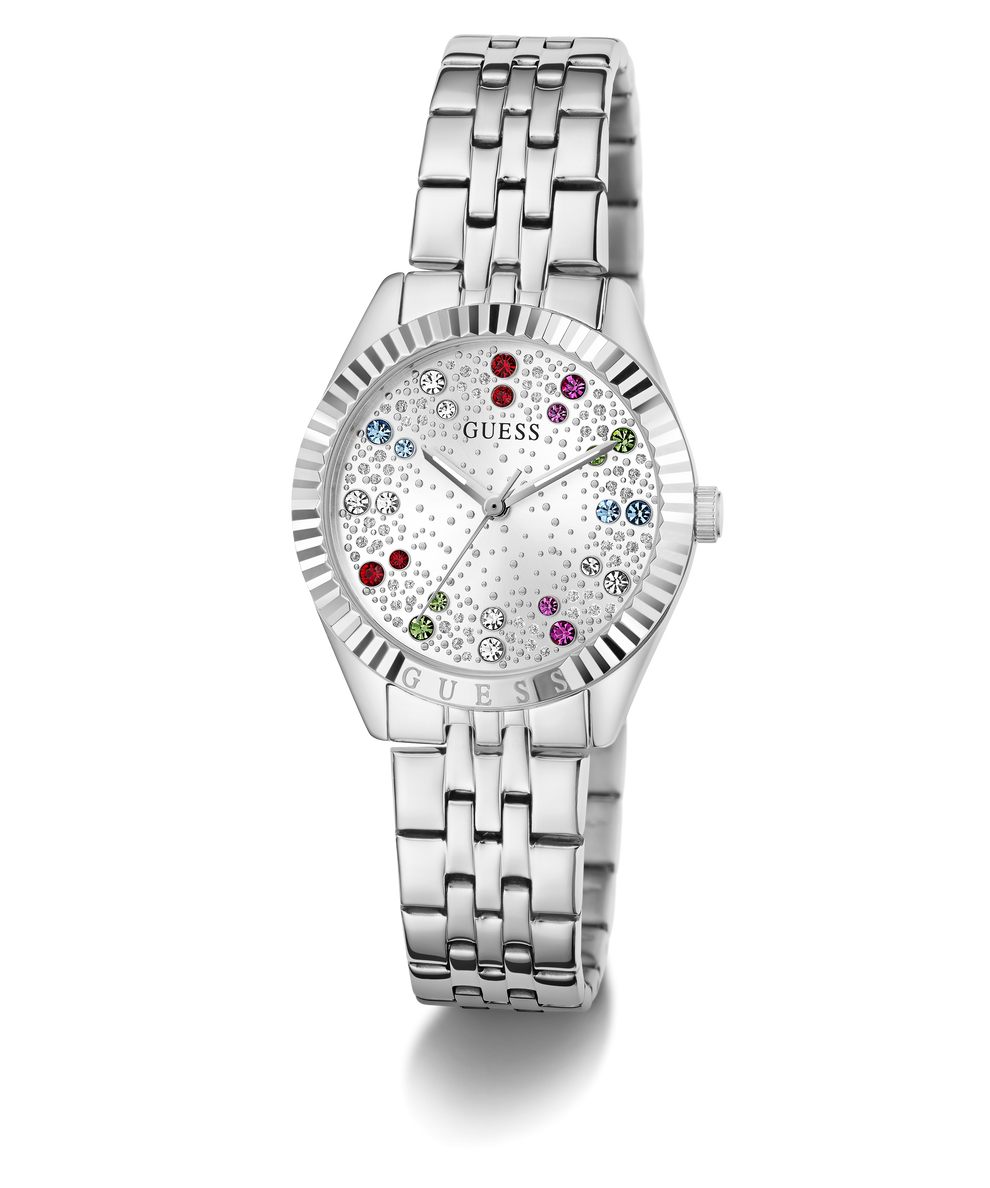 A silver-tone stainless steel wristwatch by Guess with a fluted bezel, a silver-tone link bracelet, and a white dial decorated with tiny floral patterns and colorful crystal hour markers.