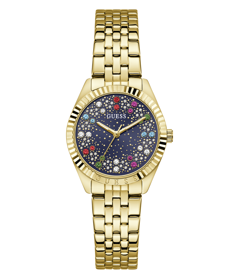 A gold-tone stainless steel wrist watch by Guess with a dark blue dial decorated with colorful rhinestones and white star details, set against a plain white background.