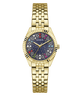 A gold-tone stainless steel wrist watch by Guess with a dark blue dial decorated with colorful rhinestones and white star details, set against a plain white background.