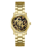 A gold-tone Guess wristwatch with a metal link bracelet, a tortoiseshell-patterned dial, and crystal accents around the bezel and around the hour markers.