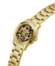 Gold-tone Guess watch with a metal link bracelet, crystal-studded bezel, and a dark tortoiseshell dial featuring the Guess logo. lifestyle