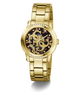 A gold-tone Guess wristwatch with a metal link bracelet, a round bezel set with small clear crystals, and a dark patterned dial featuring the Guess logo.