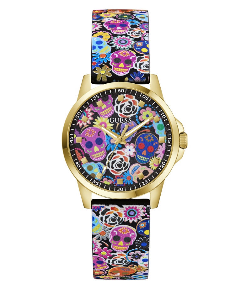 A Guess wristwatch with a gold-tone case and a colorful Day of the Dead patterned strap and dial, featuring sugar skulls, flowers, and butterflies on a white background.