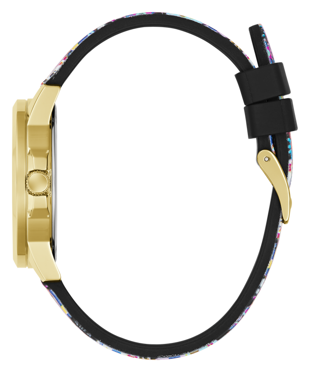 A close-up side view of a watch with a gold-tone case and a black strap featuring a colorful speckled pattern, set against a plain white background.