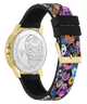 A Guesst watch shown from the back, featuring a gold-tone case, a silver-tone back with a sugar skull engraving, and a black silicone strap with a vibrant multicolor floral and sugar skull pattern.