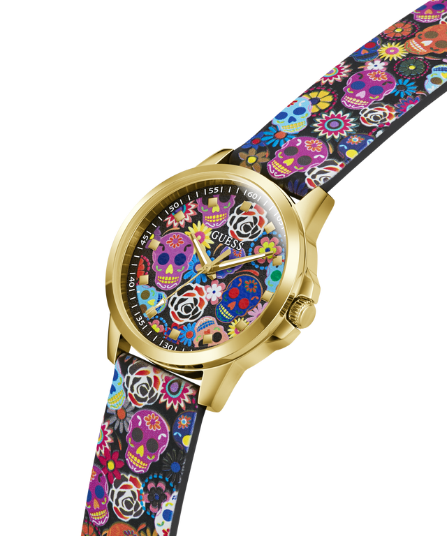 A GUESS wristwatch with a gold-tone case and a colorful sugar skull patterned strap and dial, shown on a plain white background. lifestyle