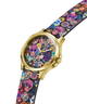 A GUESS wristwatch with a gold-tone case and a colorful sugar skull patterned strap and dial, shown on a plain white background. lifestyle