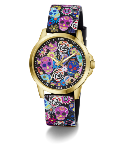 A GUESS women's watch featuring a gold-tone case and a black strap decorated with a colorful Day of the Dead sugar skull and floral pattern, set against a plain white background.