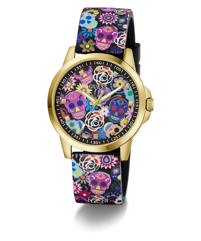 A GUESS women's watch featuring a gold-tone case and a black strap decorated with a colorful Day of the Dead sugar skull and floral pattern, set against a plain white background.