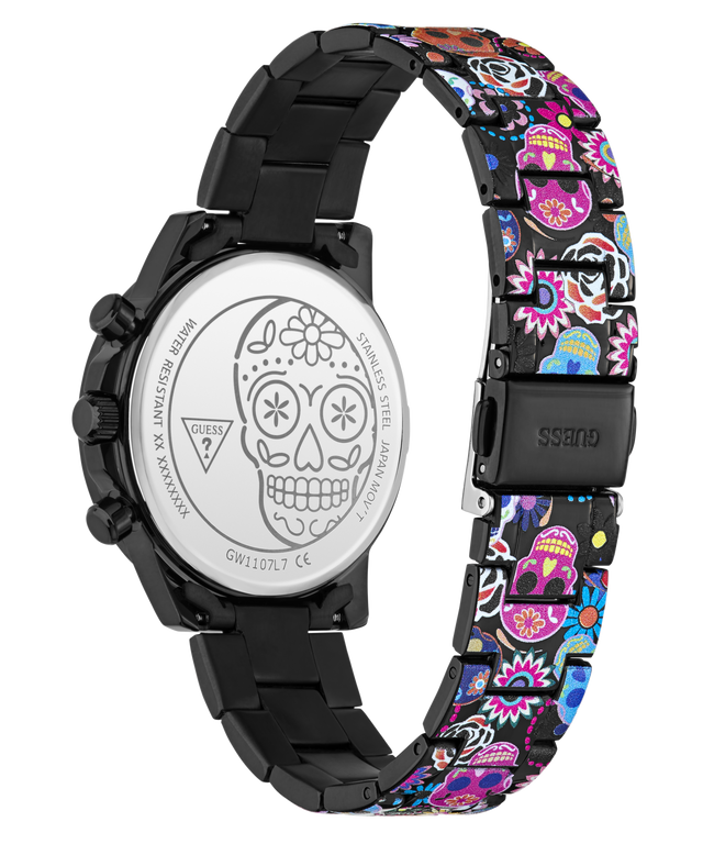 A Guess women's watch with a black stainless steel case and a colorful Day of the Dead patterned link band, shown from the back to reveal the engraved silver case back with a sugar skull design.