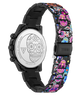 A Guess women's watch with a black stainless steel case and a colorful Day of the Dead patterned link band, shown from the back to reveal the engraved silver case back with a sugar skull design.