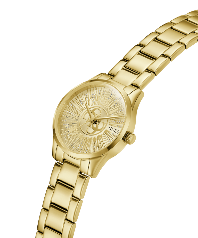 Gold-tone women's analog watch with a matching metal link bracelet, a sunburst dial, and a visible GUESS logo on the watch face, shown on a plain white background. lifestyle