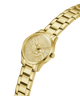Gold-tone women's analog watch with a matching metal link bracelet, a sunburst dial, and a visible GUESS logo on the watch face, shown on a plain white background. lifestyle
