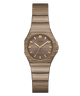 A Guess women's analog watch featuring a metallic bronze-tone case and integrated link bracelet, with a matching wood-grain textured dial and gold-tone hour markers.