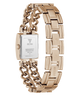 A rose gold-tone stainless steel watch by Guess, shown from the back with its rectangular case and link bracelet visible against a plain white background.