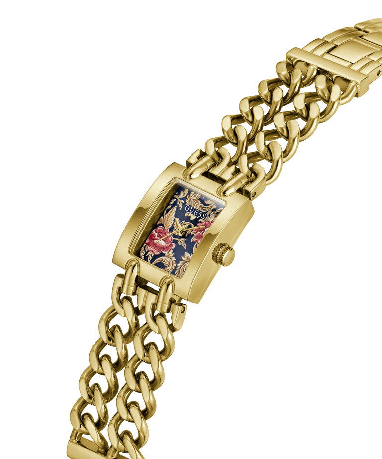 A gold-tone metal watch with a chunky curb-link bracelet and a rectangular face featuring a floral and dragon design on a navy blue background. lifestyle