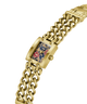 A gold-tone metal watch with a chunky curb-link bracelet and a rectangular face featuring a floral and dragon design on a navy blue background. lifestyle