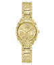 Gold-tone Guess watch with an ornate floral and scroll patterned metal bracelet and matching case, featuring a gold dial with Roman numerals and crystal hour markers.