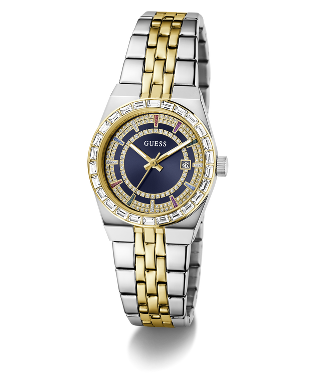 A Guess women's two-tone stainless steel and yellow gold watch with a blue dial, crystal-embellished bezel, and date window, shown on a clean white background.