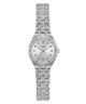 A women's Guess watch with a silver-tone metal bracelet and case, heavily embellished with clear crystals. The silver dial features Roman numeral XII at the 12 o'clock position and crystal hour markers, with the GUESS brand name printed below it.