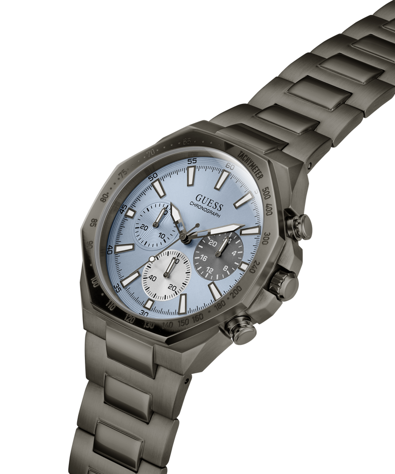 A Guess chronograph watch with a dark gray metal link bracelet, a dark gray bezel, and a light blue dial with white sub-dials and markers. lifestyle