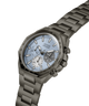 A Guess chronograph watch with a dark gray metal link bracelet, a dark gray bezel, and a light blue dial with white sub-dials and markers. lifestyle