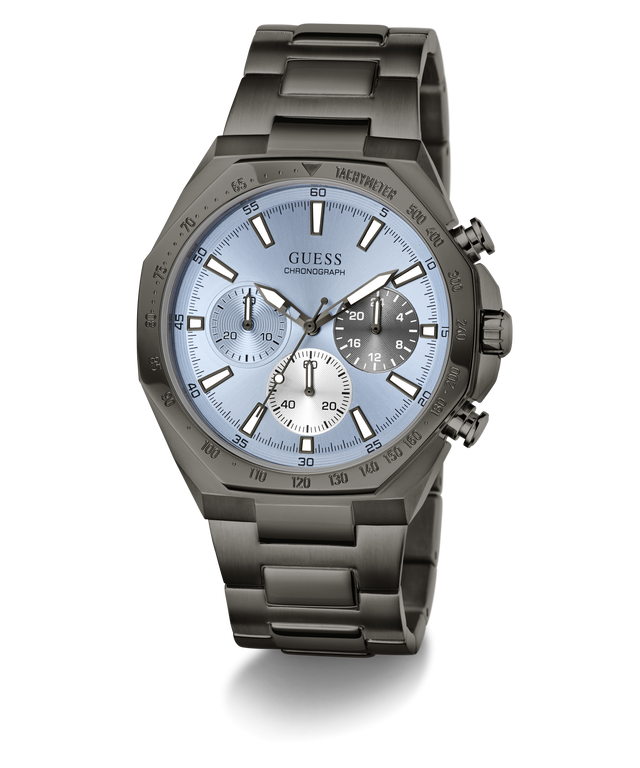 A GUESS chronograph watch with a dark gunmetal gray stainless steel case and link bracelet, featuring a light blue dial with white and black sub-dials.
