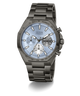 A GUESS chronograph watch with a dark gunmetal gray stainless steel case and link bracelet, featuring a light blue dial with white and black sub-dials.