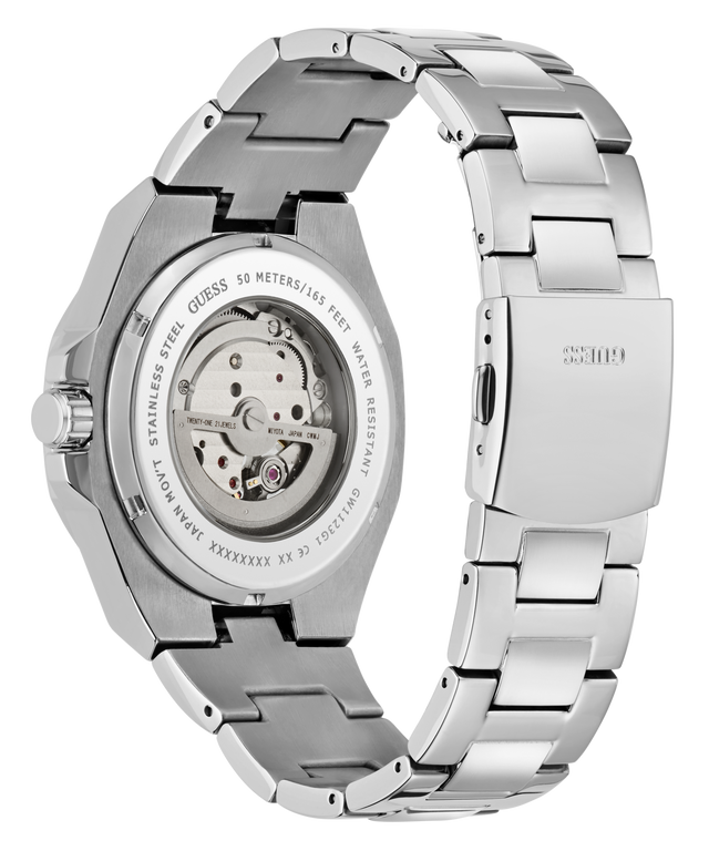 A stainless steel wristwatch shown from the back, featuring a transparent case back that reveals the mechanical movement and a matching stainless steel link bracelet. The brand name 'Guess' is engraved on the clasp.