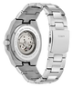 A stainless steel wristwatch shown from the back, featuring a transparent case back that reveals the mechanical movement and a matching stainless steel link bracelet. The brand name 'Guess' is engraved on the clasp.