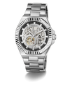 A GUESS men's skeleton watch with a silver stainless steel case and bracelet, featuring a black dial with a skeletonized openwork design that reveals the inner mechanical movement.