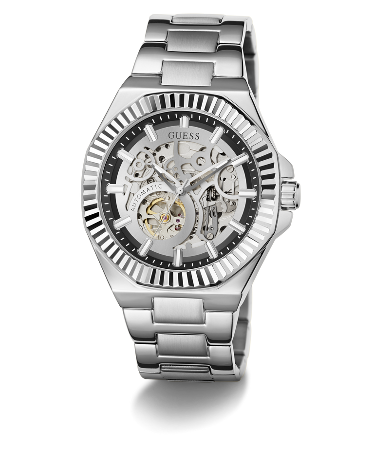 A GUESS men's skeleton watch with a silver stainless steel case and bracelet, featuring a black dial with a skeletonized openwork design that reveals the inner mechanical movement.