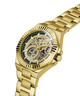 Gold-tone automatic watch with a skeleton dial and matching gold-tone metal link bracelet, shown on a clean white background. lifestyle