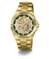 Gold-tone GUESS wristwatch with a skeleton dial, featuring a gold metal link bracelet, ridged bezel, and dark green inner dial details.