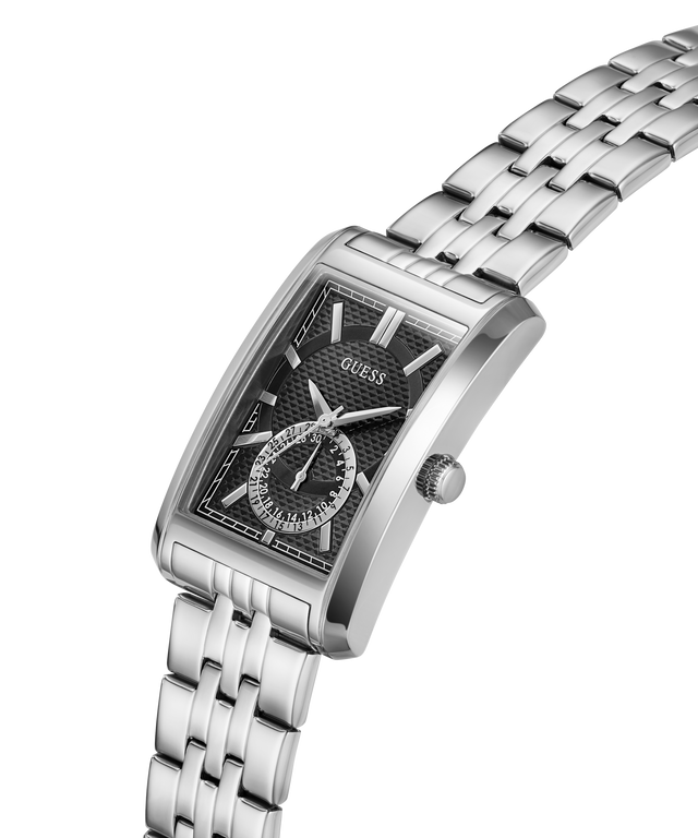 A GUESS men's stainless steel analog watch with a rectangular case, black textured dial, and matching steel link bracelet, shown on a clean white background. lifestyle