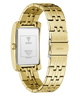 Gold-tone stainless steel women's watch with a rectangular case and matching metal link bracelet, shown on a white background. The back of the case is visible with GUESS branding and technical specifications, and the clasp also shows the GUESS logo.