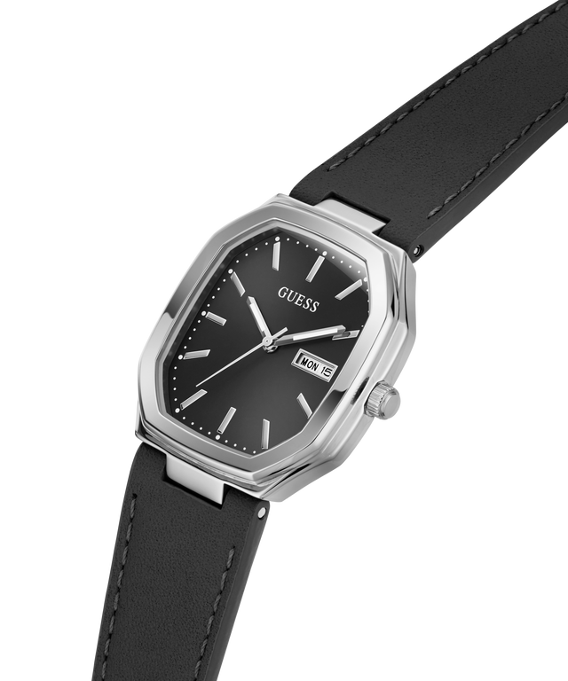 A Guess wristwatch with a black dial, silver-tone case, and black leather strap, shown on a plain white background. lifestyle