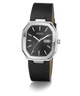 A GUESS analog watch with a black dial, silver-tone stainless steel case, and a black leather strap with white stitching, shown on a clean white background.